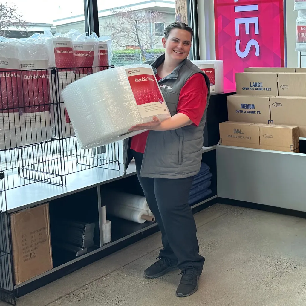 on-site manager holding bubble wrap for sale at security public storage