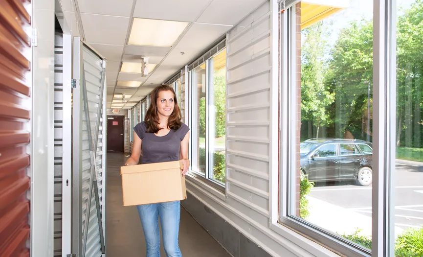 Customer moving boxes into a climate-controlled storage unit at Security Public Storage in Herndon