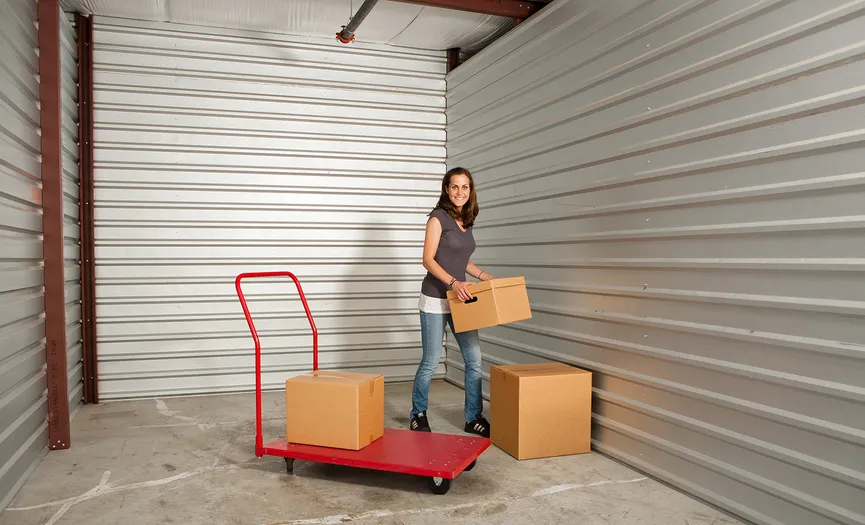 Customer stacking boxes inside a climate-controlled storage unit at Security Public Storage near Downtown Herndon