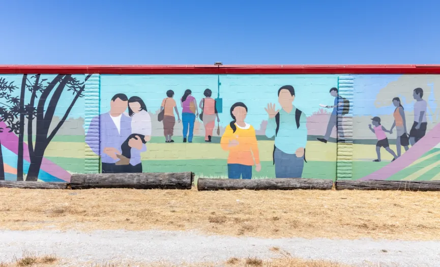 South wall mural with people gathering and greeting in a park-like setting near Security Public Storage at 271 Sun Way in Salinas, CA