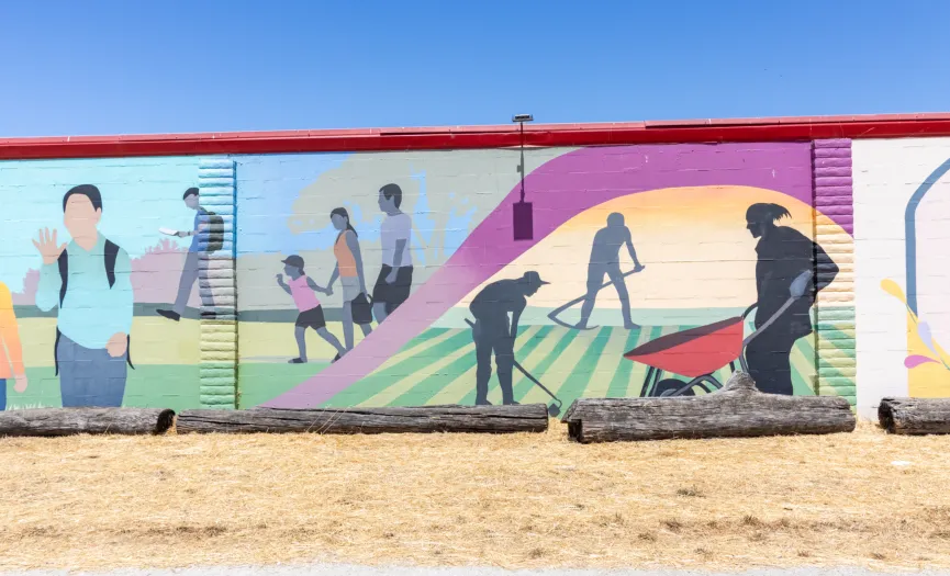 South wall mural showing silhouettes of field work, tools, and a wheelbarrow near Security Public Storage at 271 Sun Way, Salinas CA