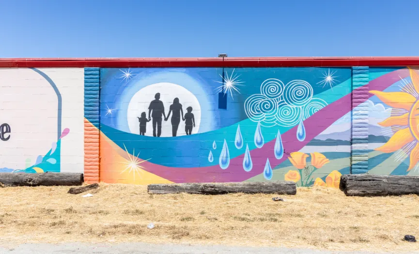 South wall mural featuring a family silhouette, raindrops, and poppy flowers near Security Public Storage at 271 Sun Way, Salinas CA
