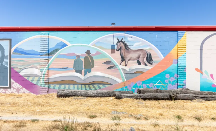 Mural depicting a book and horse symbolizing John Steinbeck’s Salinas Valley stories near Security Public Storage on Sun Way in Salinas, CA