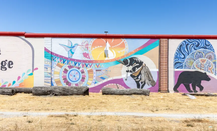 Mural honoring Indigenous roots of Salinas with cultural symbols near Security Public Storage on Sun Way, CA