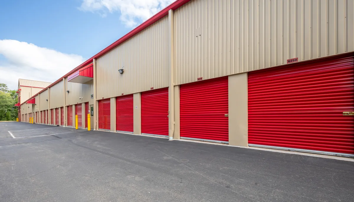 A row of Security Public Storage units with bright red roll-up doors